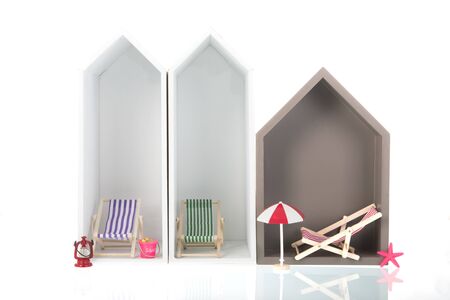 Modern beach houses with deck chairs isolated over white backgroundの写真素材