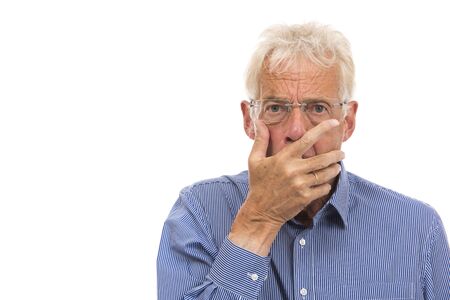 Portrait senior man in shock isolated against white backgroundの写真素材