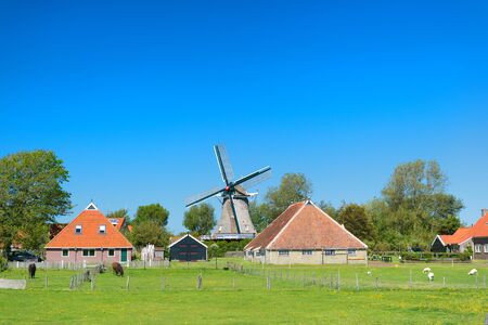 Typical Dutch landscape with windmillの写真素材