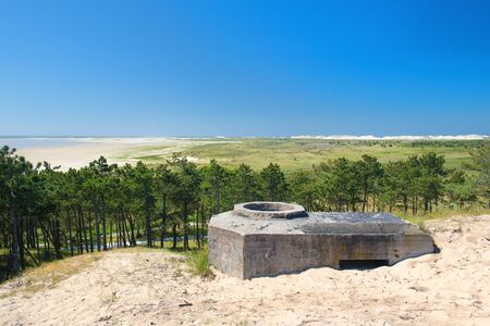 Old bunker at the beach on Dutch island Terschellingの写真素材