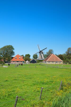 Typical Dutch landscape with windmillの写真素材
