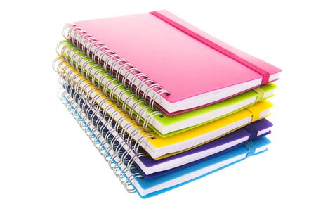 Stacked colorful notebooks isolated over white backgroundの写真素材