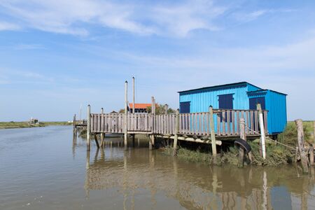 Blue French wooden oyster huts in landscape in the France Charente Maritimeの写真素材