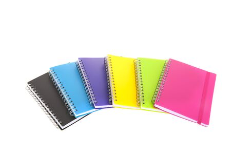 Row colorful notebooks isolated over white backgroundの写真素材