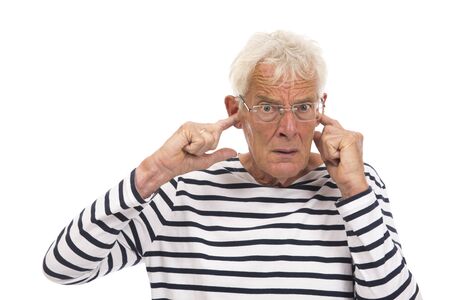 Senior man with too much noise isolated over white backgroundの写真素材