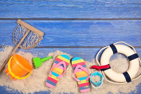 Vacation background with beach sand and blue woodの写真素材