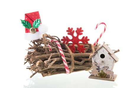 Natural Christmas decoration with wooden bunch branches, snowflakes and bird boxの写真素材