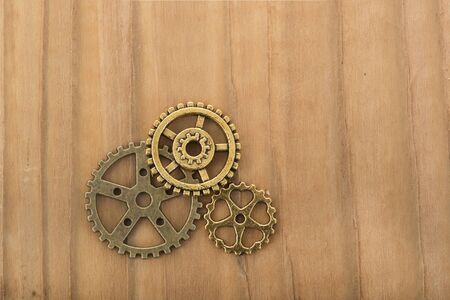 Industrial wheels in copper on wooden backgroundの写真素材