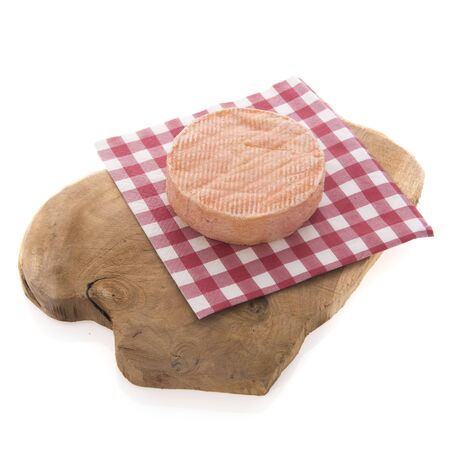 Munster cheese on cutting board isolated over white backgroundの写真素材