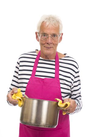 Senior houseman with pink apron holding cooking pan isolated over whiteの写真素材