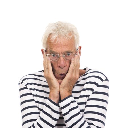 Scaring senior man with glasses isolated over white backgroundの写真素材