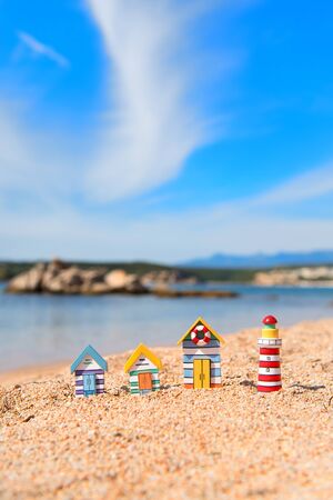 Coast with miniature wooden village and light houseの写真素材