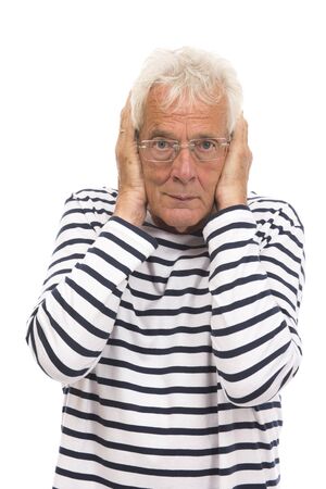 Senior man with too much noise isolated over white backgroundの写真素材