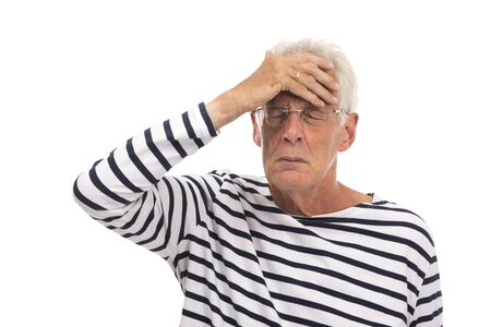Senior man with headache isolated over white backgroundの写真素材