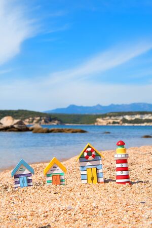 Coast with miniature wooden village and light houseの写真素材