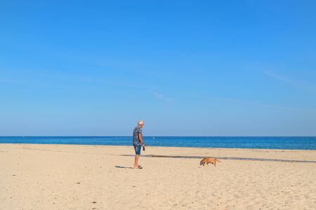 Corsica beach landscape with man and dog east coastの写真素材
