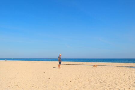 Corsica beach landscape with man and dog east coastの写真素材