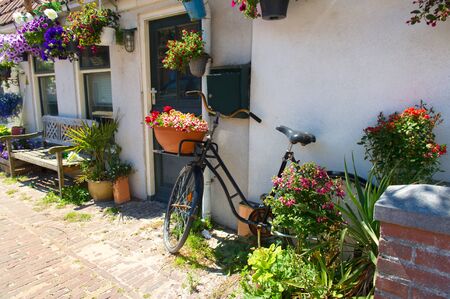 Dutch romantic house with flowers and bikeの写真素材