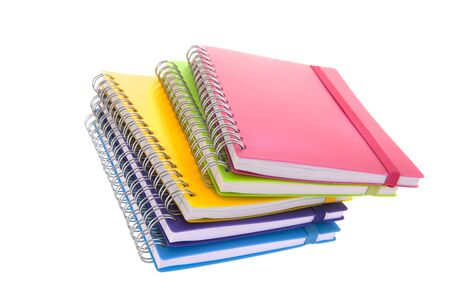 Stacked colorful notebooks isolated over whiteの写真素材