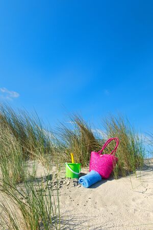 Toys in the dunes at the beachの写真素材