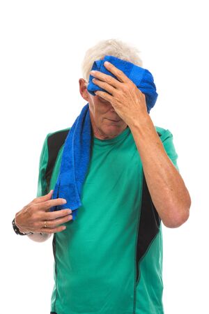 Portrait senior sport man drying head with towel against whiteの写真素材