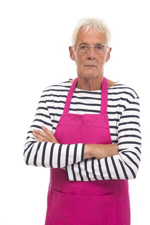 Senior houseman with pink apron isolated over whiteの写真素材
