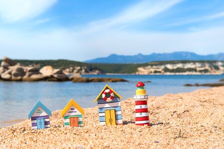 Coast with miniature wooden village and light houseの写真素材