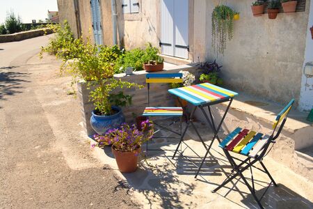 Colorful seats in little mountain village Prunelli di Fiumorbo on Corsica in Franceの写真素材