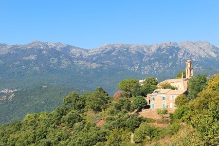 Landscape east coast Corsica France with mountains and villagesの写真素材