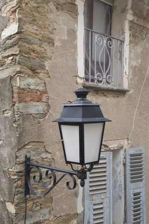Old French lantern on old houseの写真素材