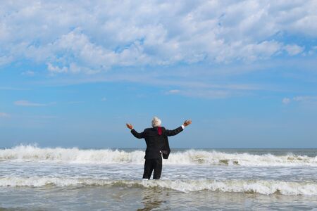 Business man in formal suit walking in the seaの写真素材