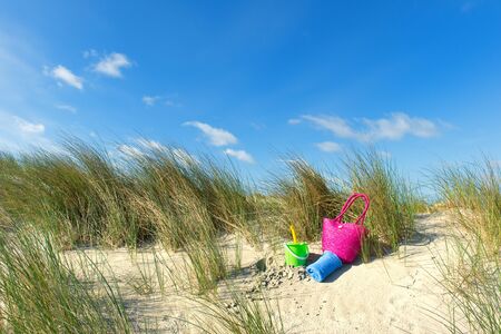 Toys in the dunes at the beachの写真素材