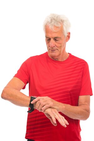 Portrait senior sport man checking time on watch on whiteの写真素材