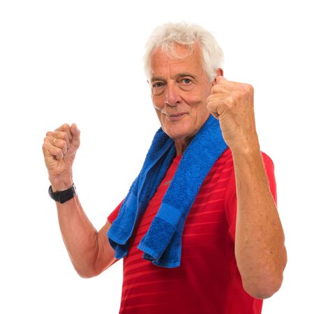 Portrait senior sport man in red with blue towel against white backgroundの写真素材