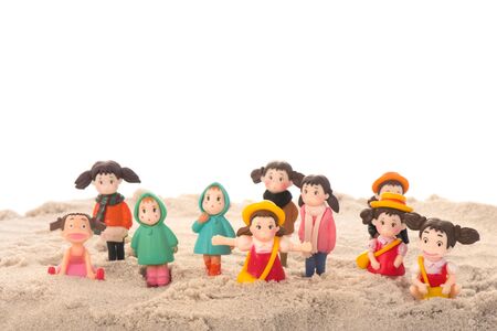 Many playing children in sand isolate against white backgroundの写真素材