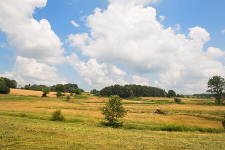 Landscape with hills and tractor in Franceの写真素材