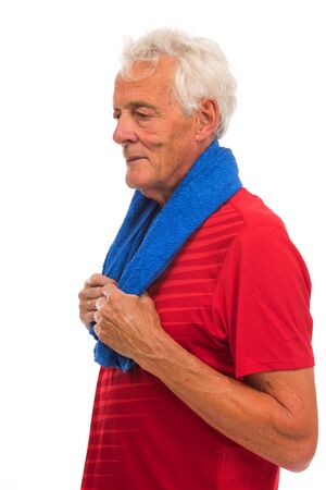 Portrait senior sport man in red with blue towel against white backgroundの写真素材
