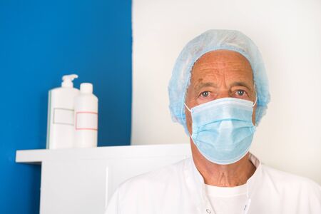Doctor with face mask and protective clothingの写真素材