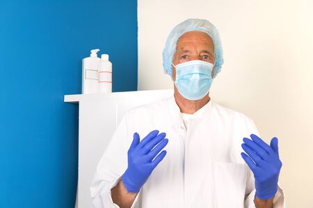 Doctor with face mask and protective clothingの写真素材