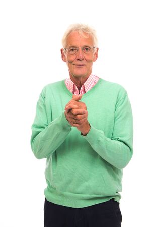 Satisfied Senior man in green jumper isolated over white backgroundの写真素材