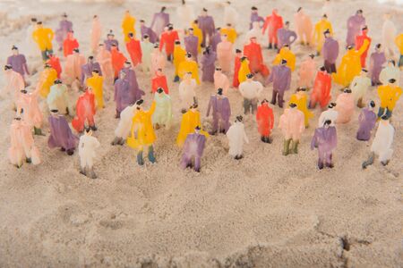 People crowd standing in sandの写真素材