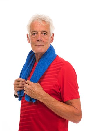 Portrait senior sport man in red with blue towel against whiteの写真素材