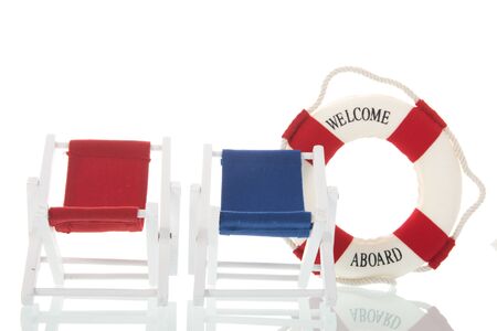 Empty deck chairs and life buoy with welcome on boardの写真素材