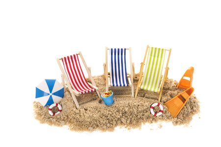 Beach chairs with parasol in sand isolated over white backgroundの写真素材