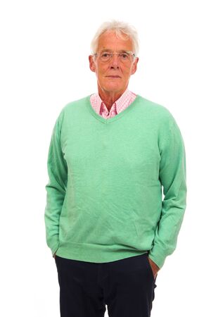 Senior man in green jumper isolated over white backgroundの写真素材