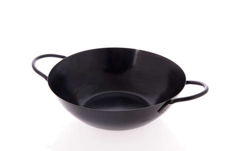 Black frying pan isolated over white backgroundの写真素材