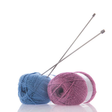 Blue and pink knitting wool with needles isolated over white backgroundの写真素材