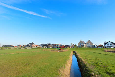 Typical Dutch landscape in Polder at village Eemdijk