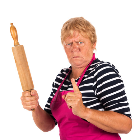 Very angry elder woman with pin roller isolated over white backgroundの写真素材