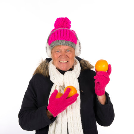 Healthy winter woman with fruit isolated over white backgroundの写真素材